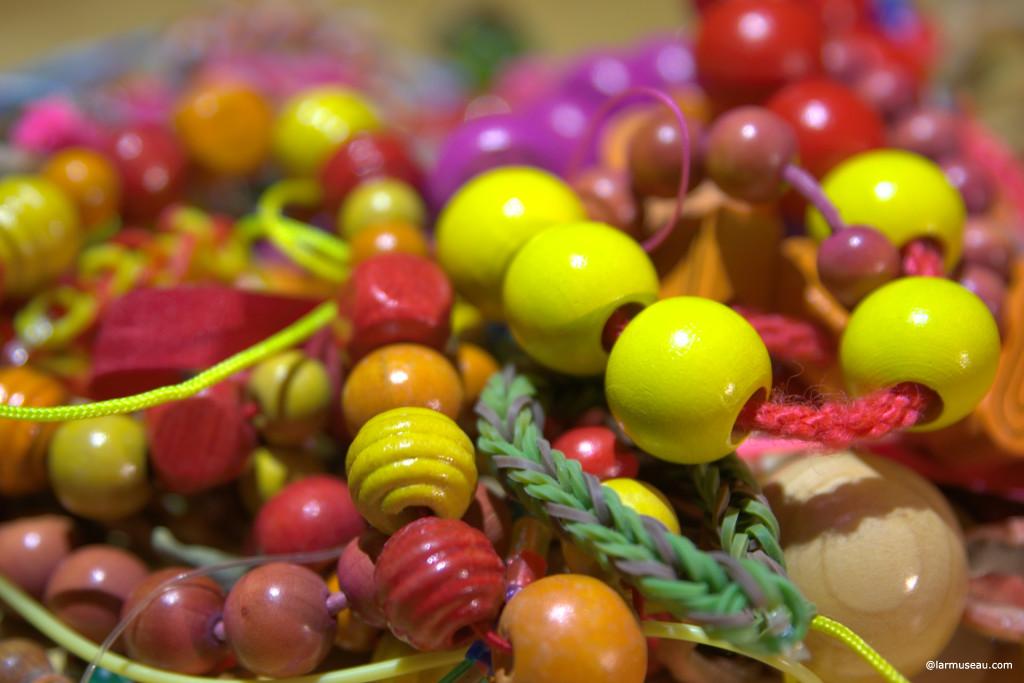 bead noun \ˈbēd\ : a small, usually round piece of glass, wood, stone, etc., that has a hole through its center and that is put on a string with other similar pieces and worn as jewelry or that is sewn onto clothing : a small, round drop of liquid (such as water or blood)